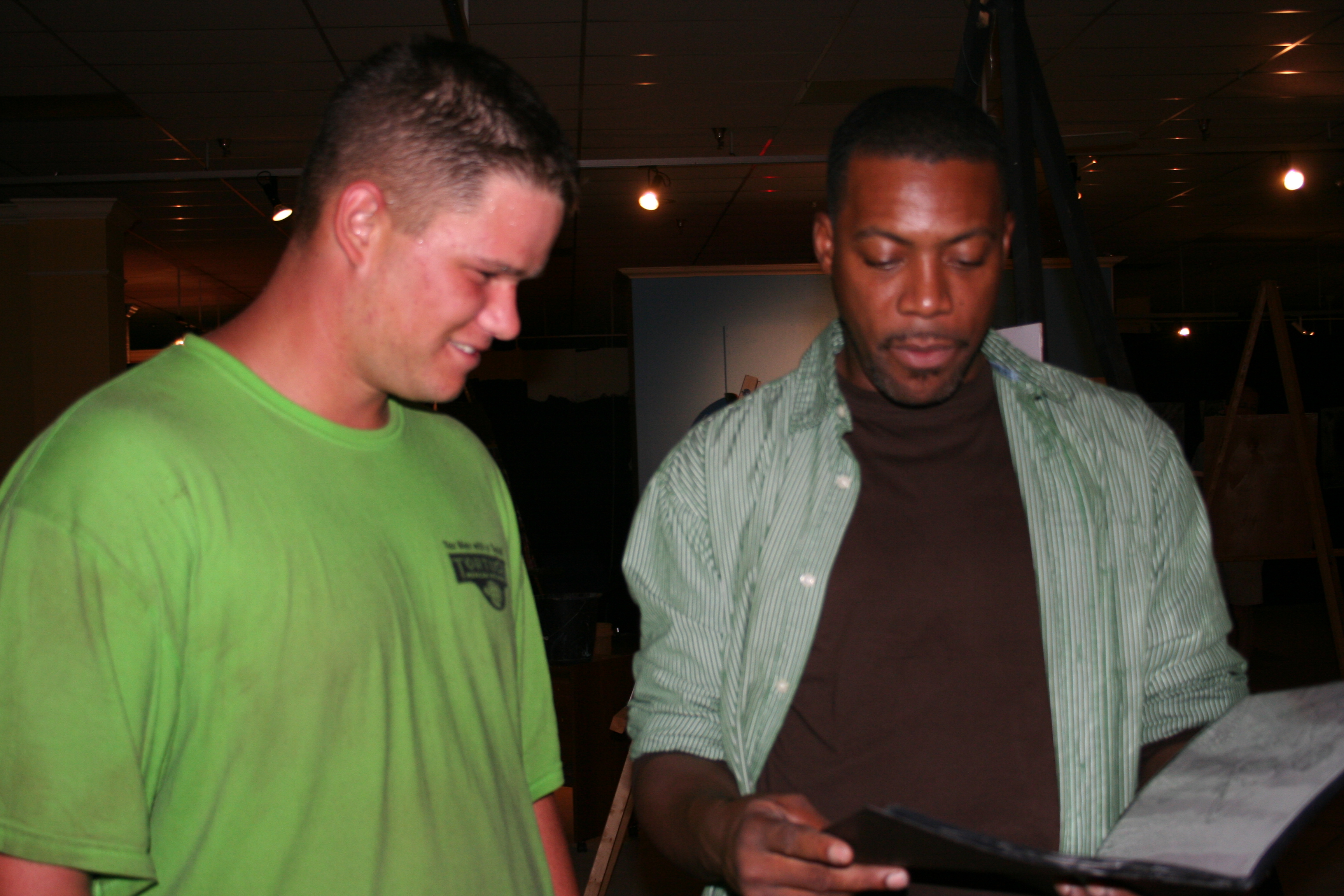 Carl Bonton shows Damien Fowler a piece of art Friday night