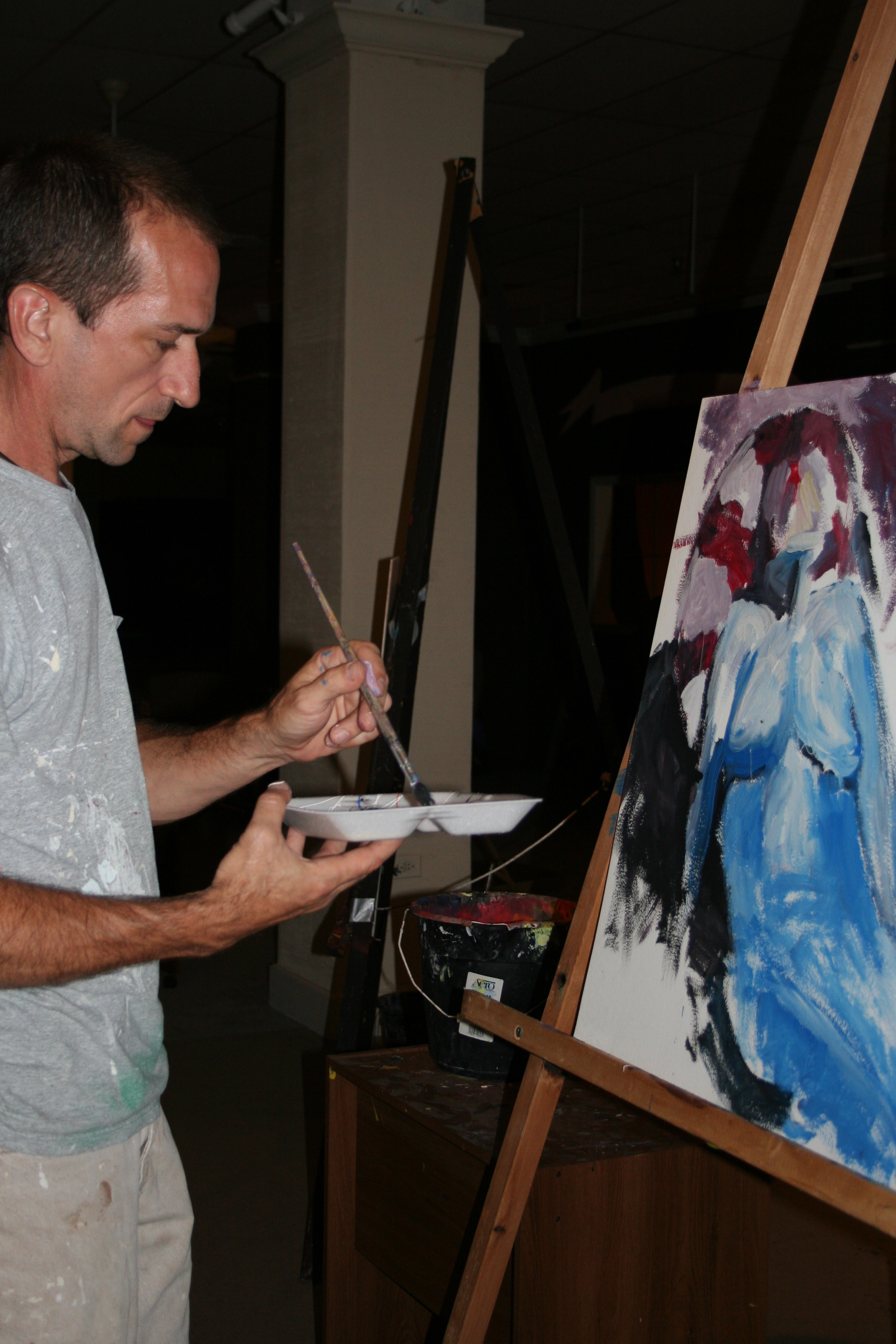 Clark Vanover works on a "blue nude" at the ArtsScene