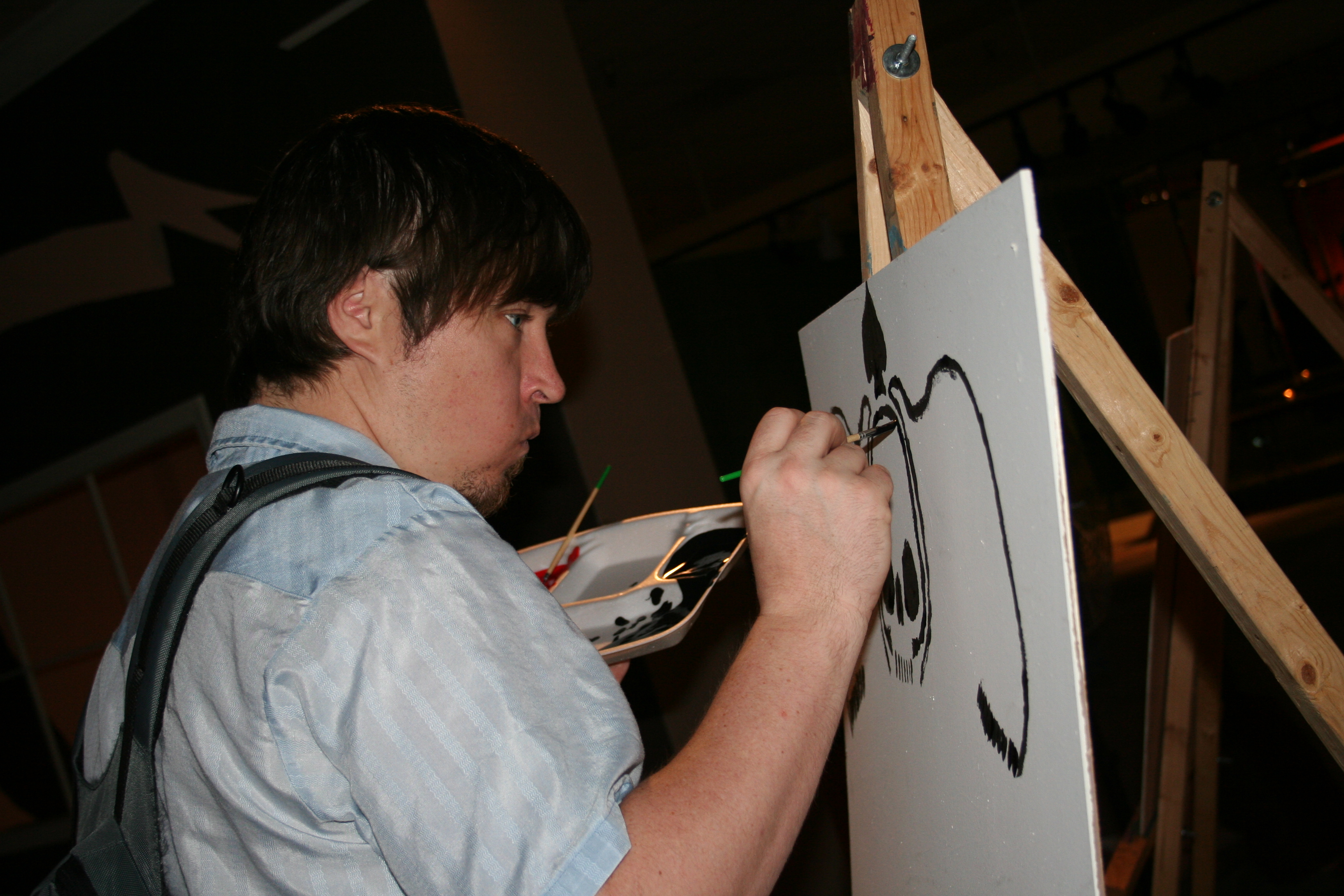A young artist concentrates on his work