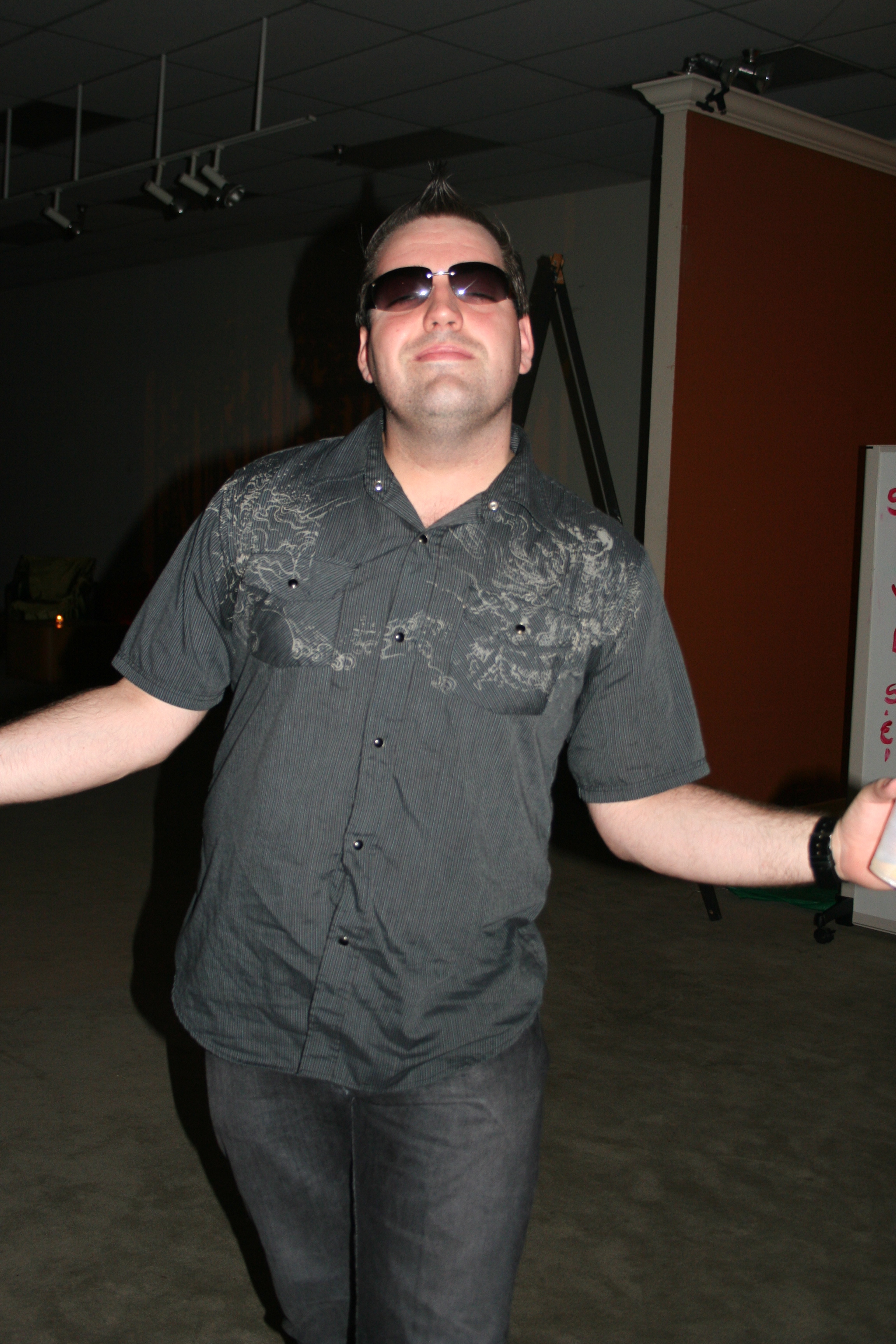 Justin Sane welcomes the camera with a smile while waiting to DJ at the art gallery