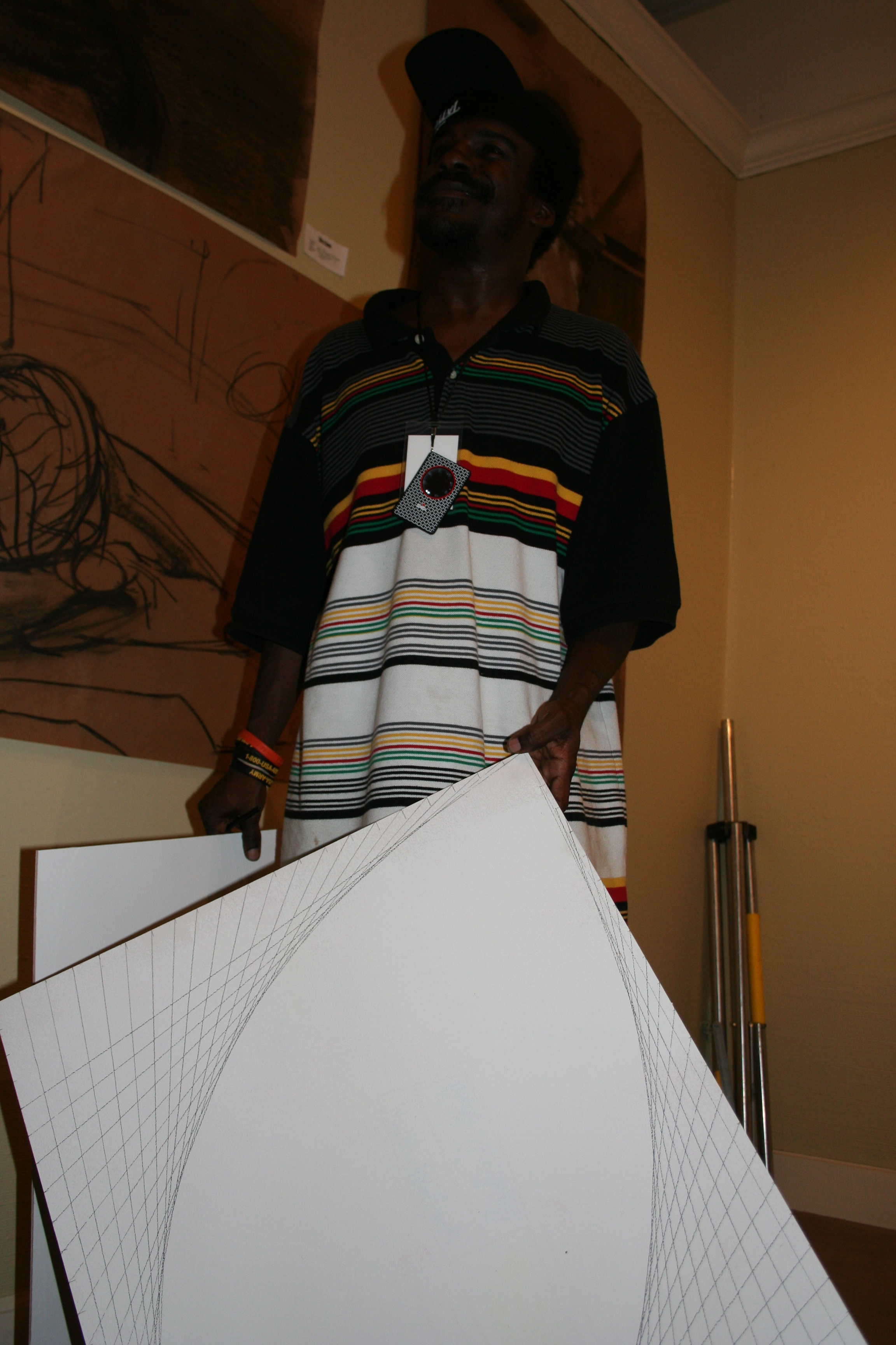 "Smokey" shows his art in progress to a passer-by at the ArtsScene