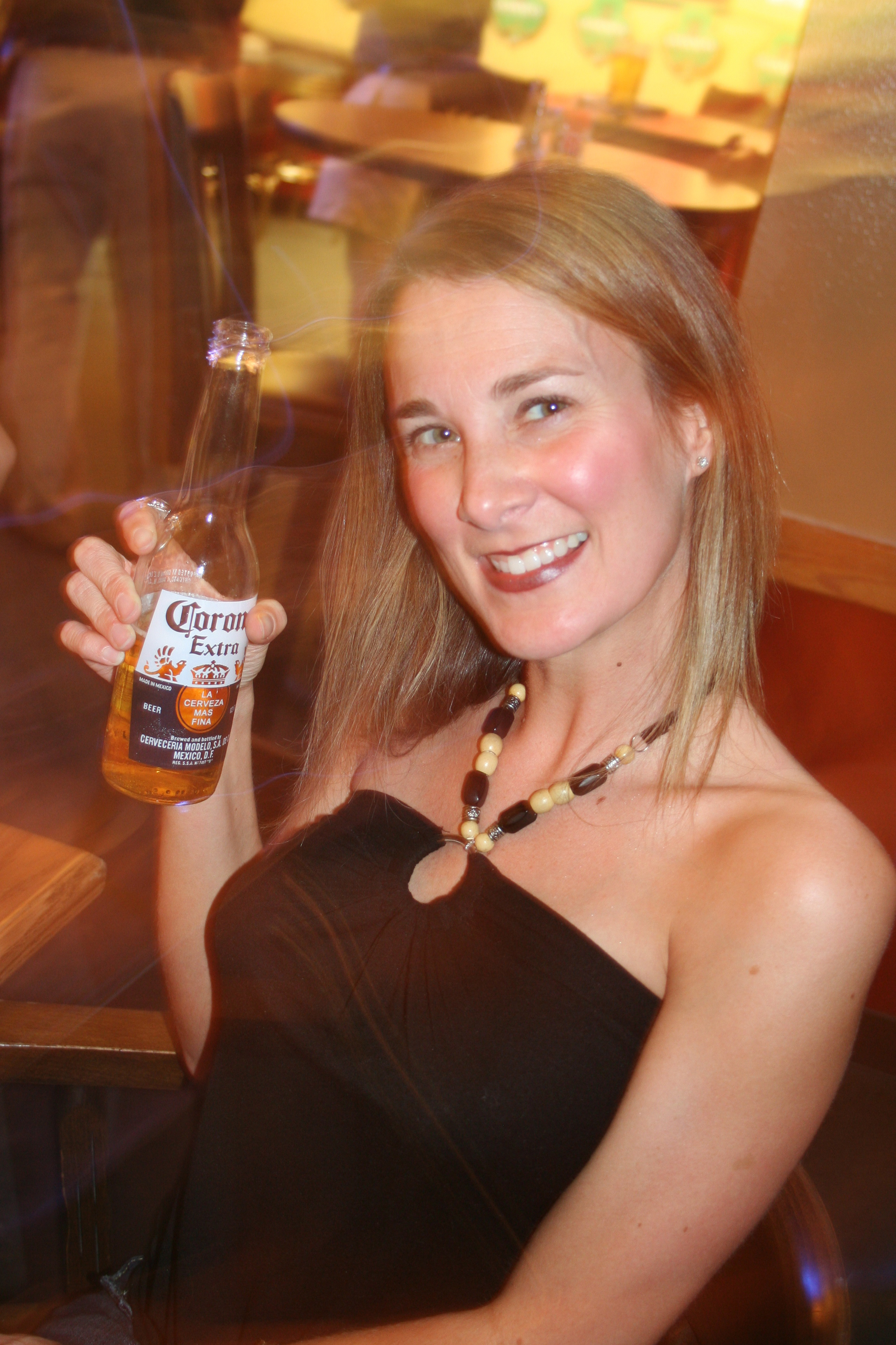 Alicia Weaver shows off her pretty smile and cool Corona at Markham St. Pub.