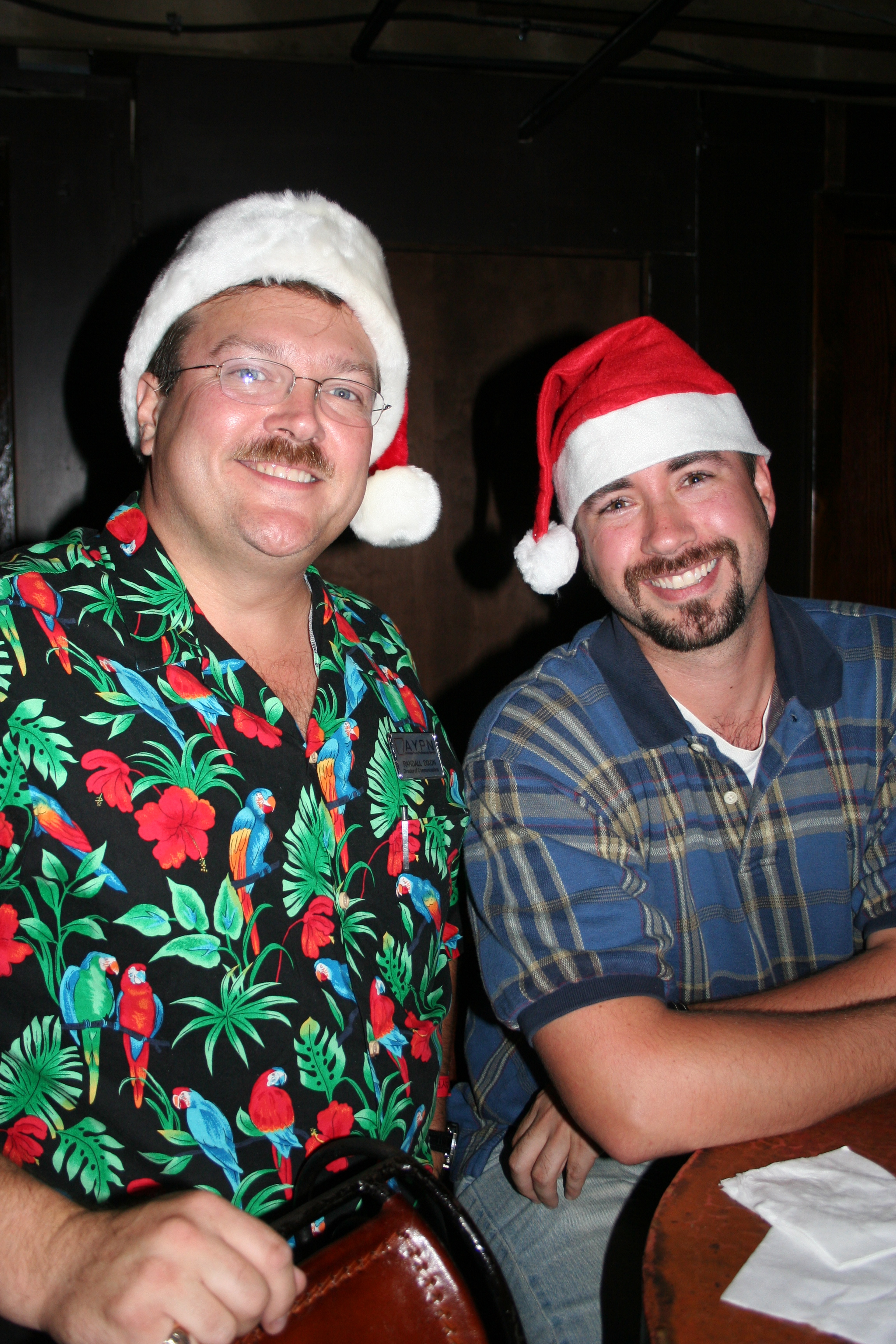 Randall Dixon and Chris Paladino show their spirit for the Christmas in July AYPN Party.
