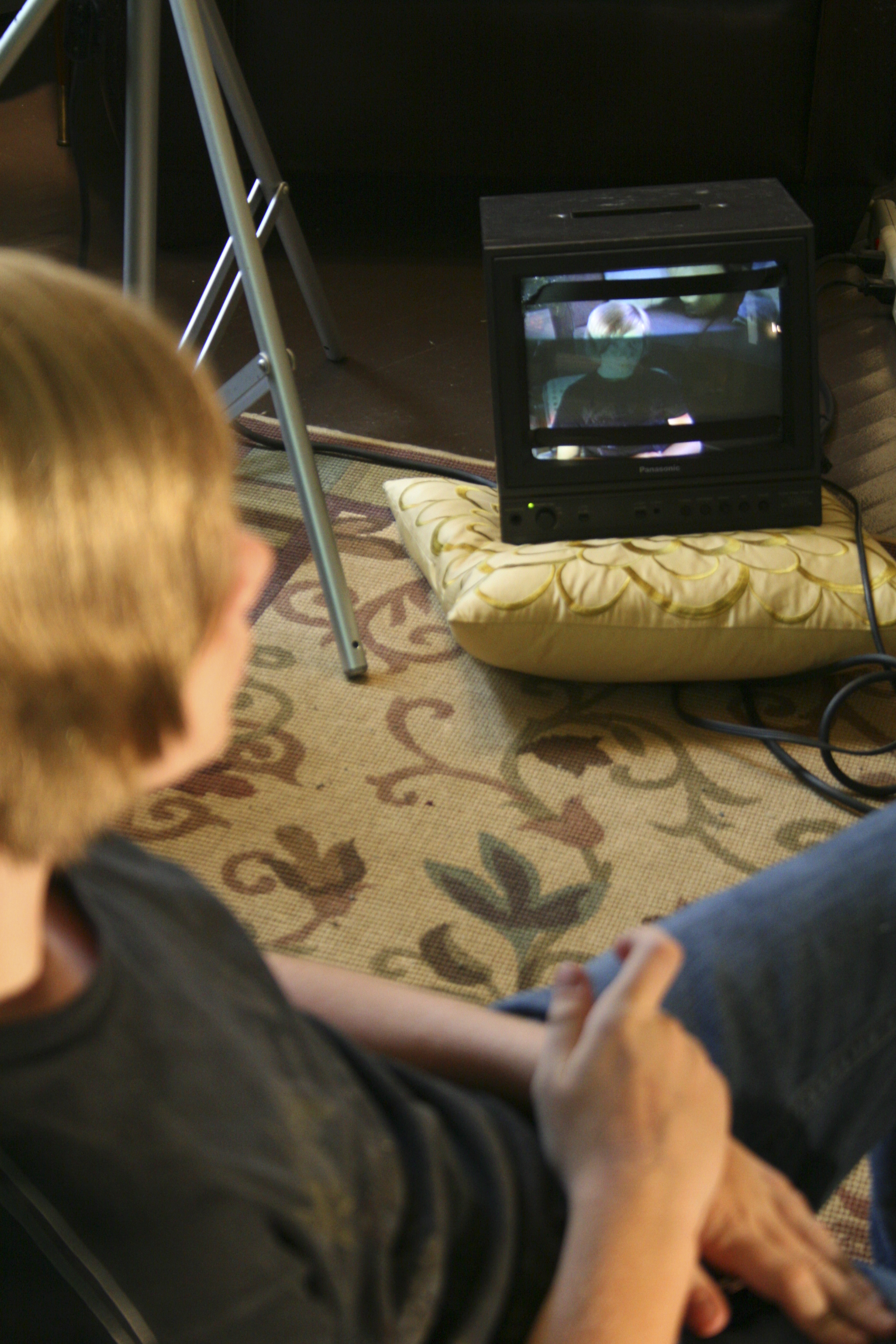 As seen in the moniter, Corey Hendricks looks at the camera waiting for his scene to begin.