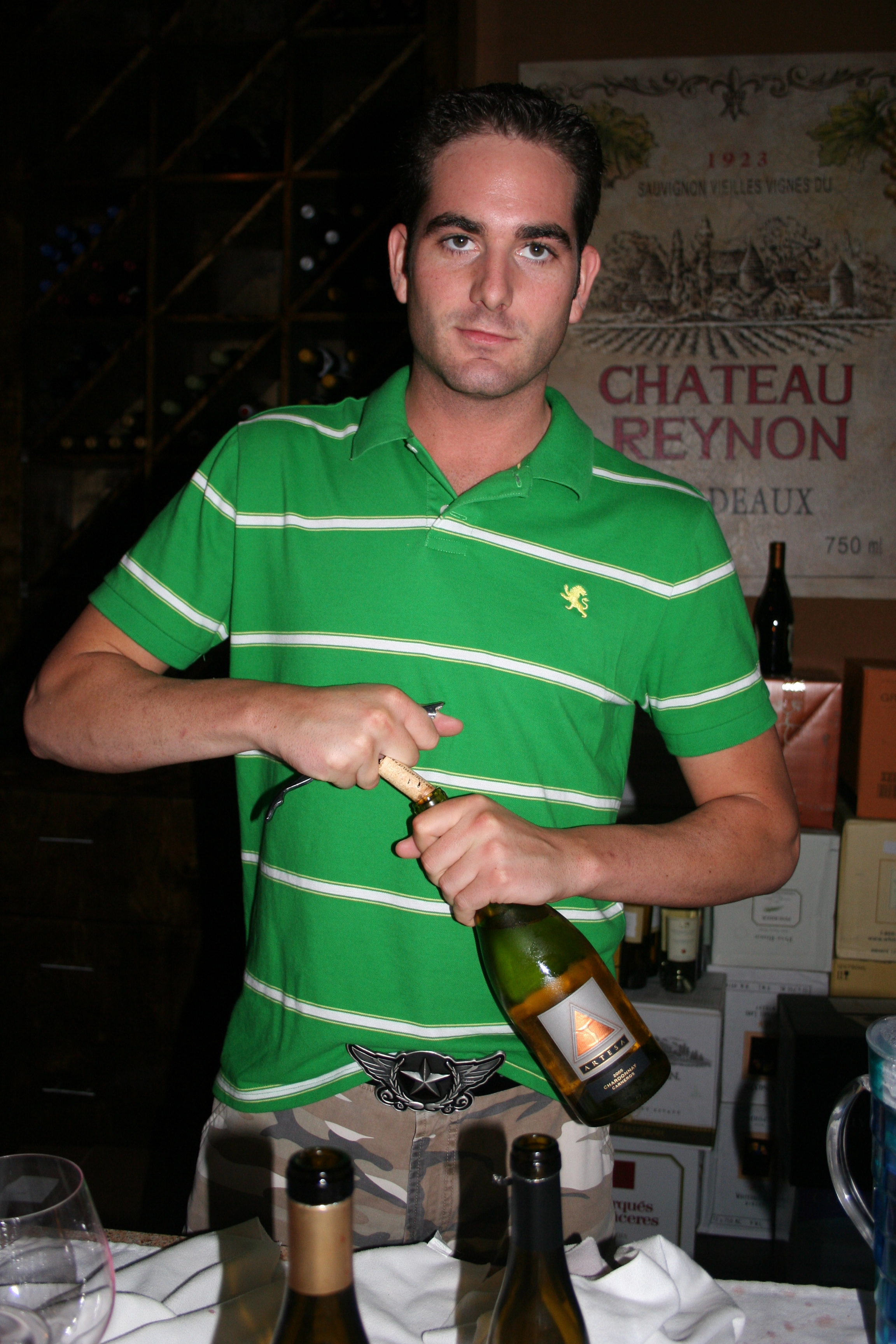 Burch, bartender, "seriously" opens a bottle of wine
