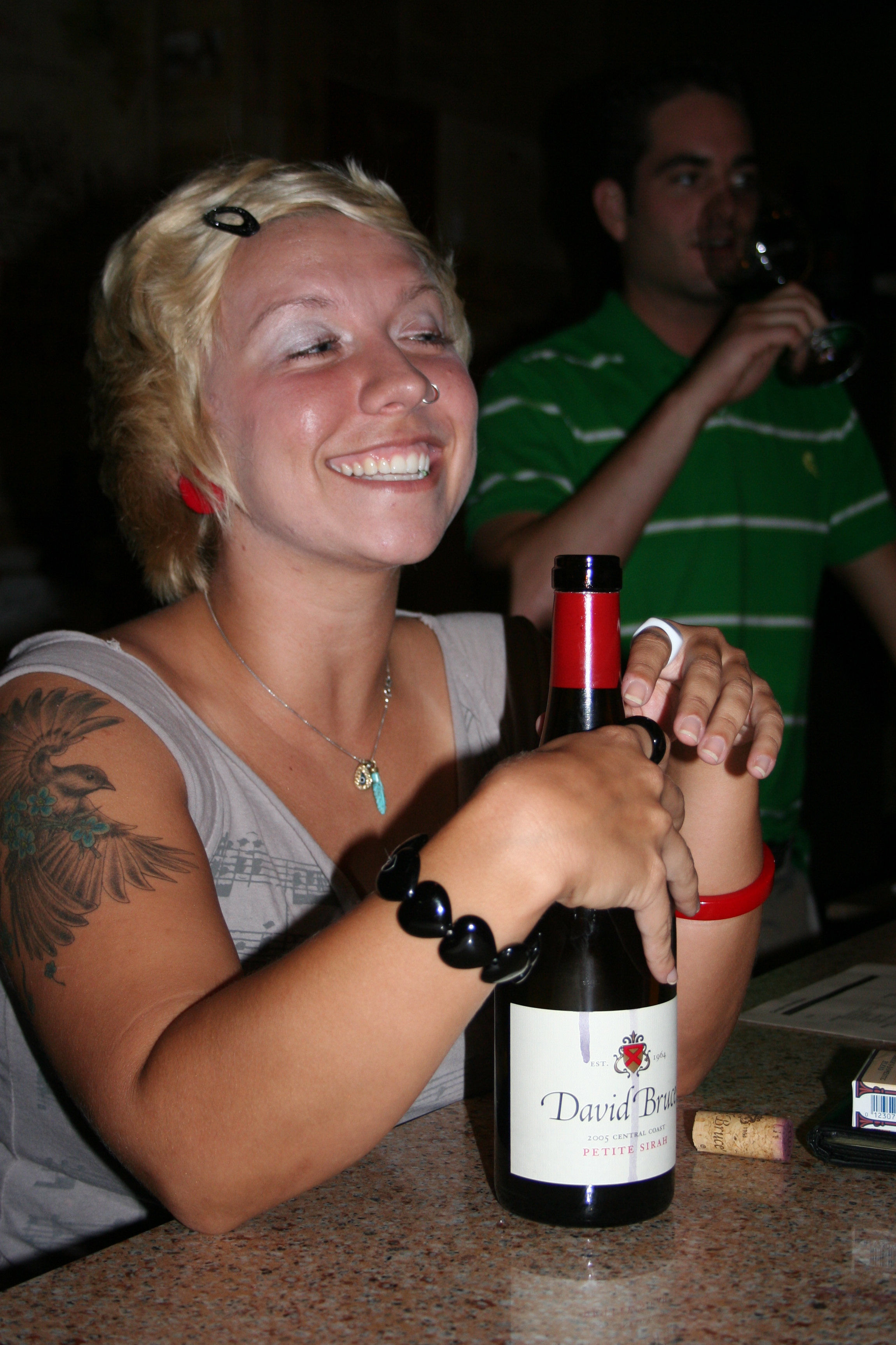 Bartender Jessica Hendricks smiles as she serves a customer.