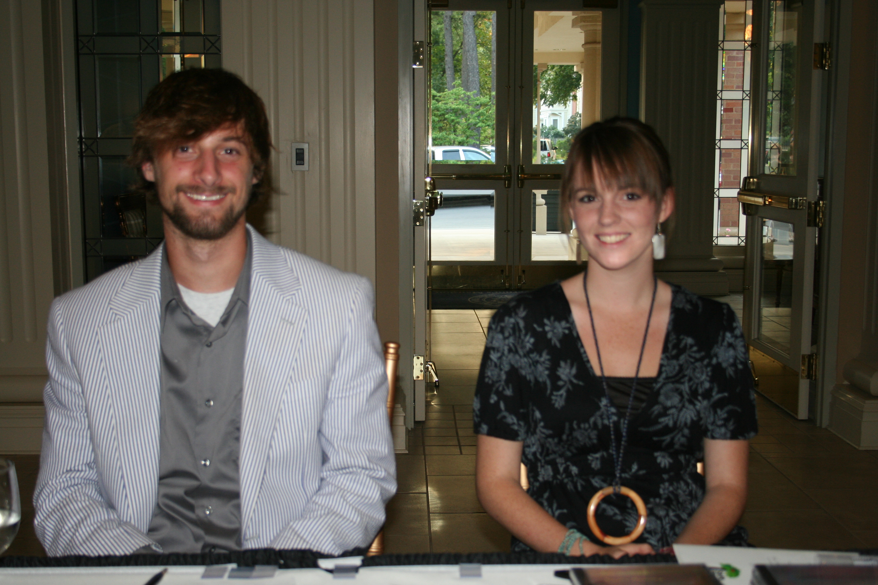 Matthew Bornhoft and Cate Davison sit at the door to support the musicians.