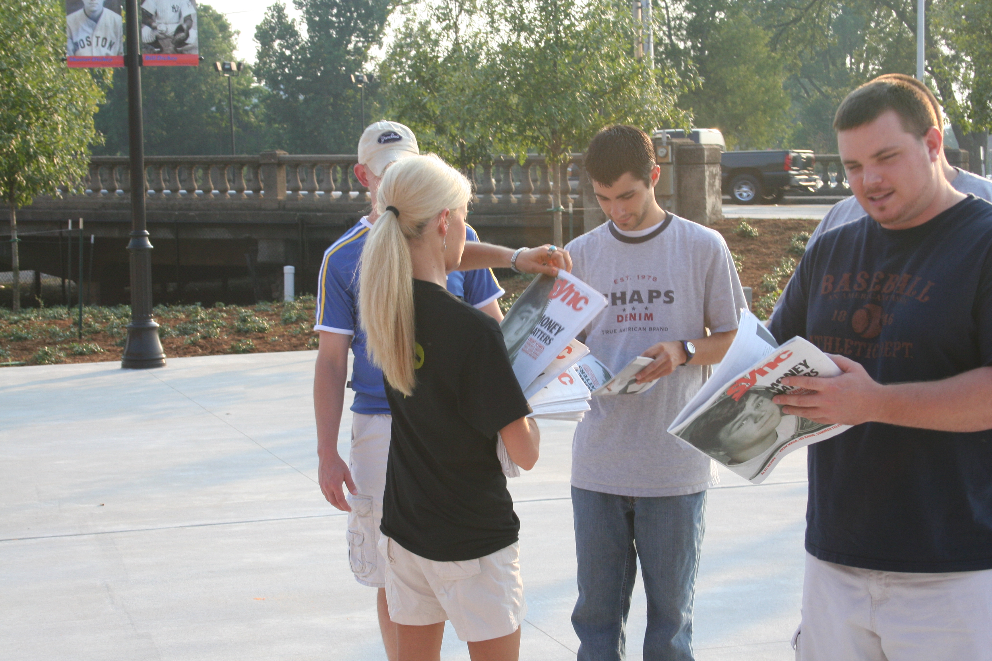 SYNC'S Lauren gives some guys the paper...with a $3 coupon for the game!