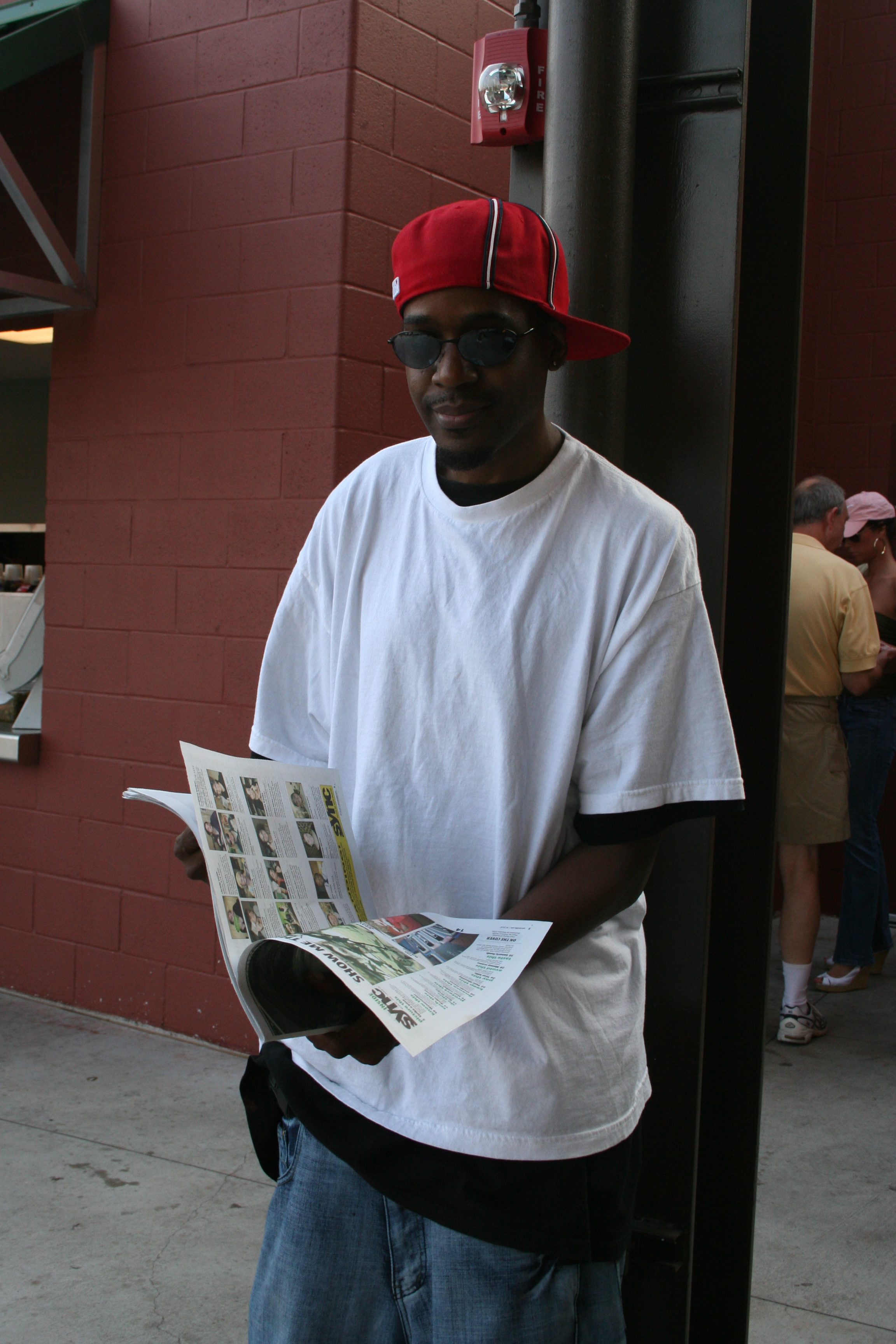 Caught ya! Carl Jackson enjoys his issue of SYNC in the concourse of the Travs' game.