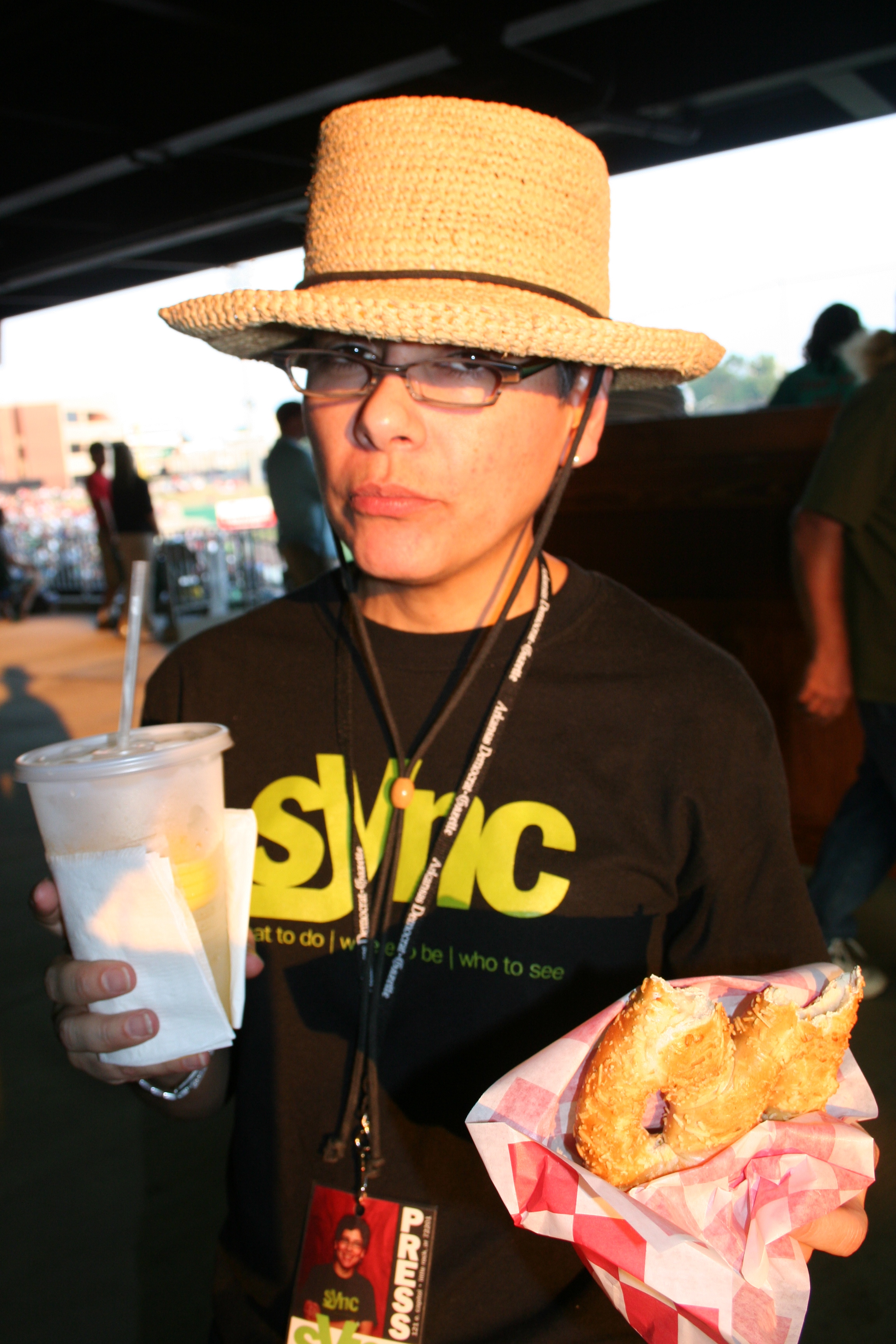Still sporting the hat...and a pretzel! Paula enjoys some ballpark treats.
