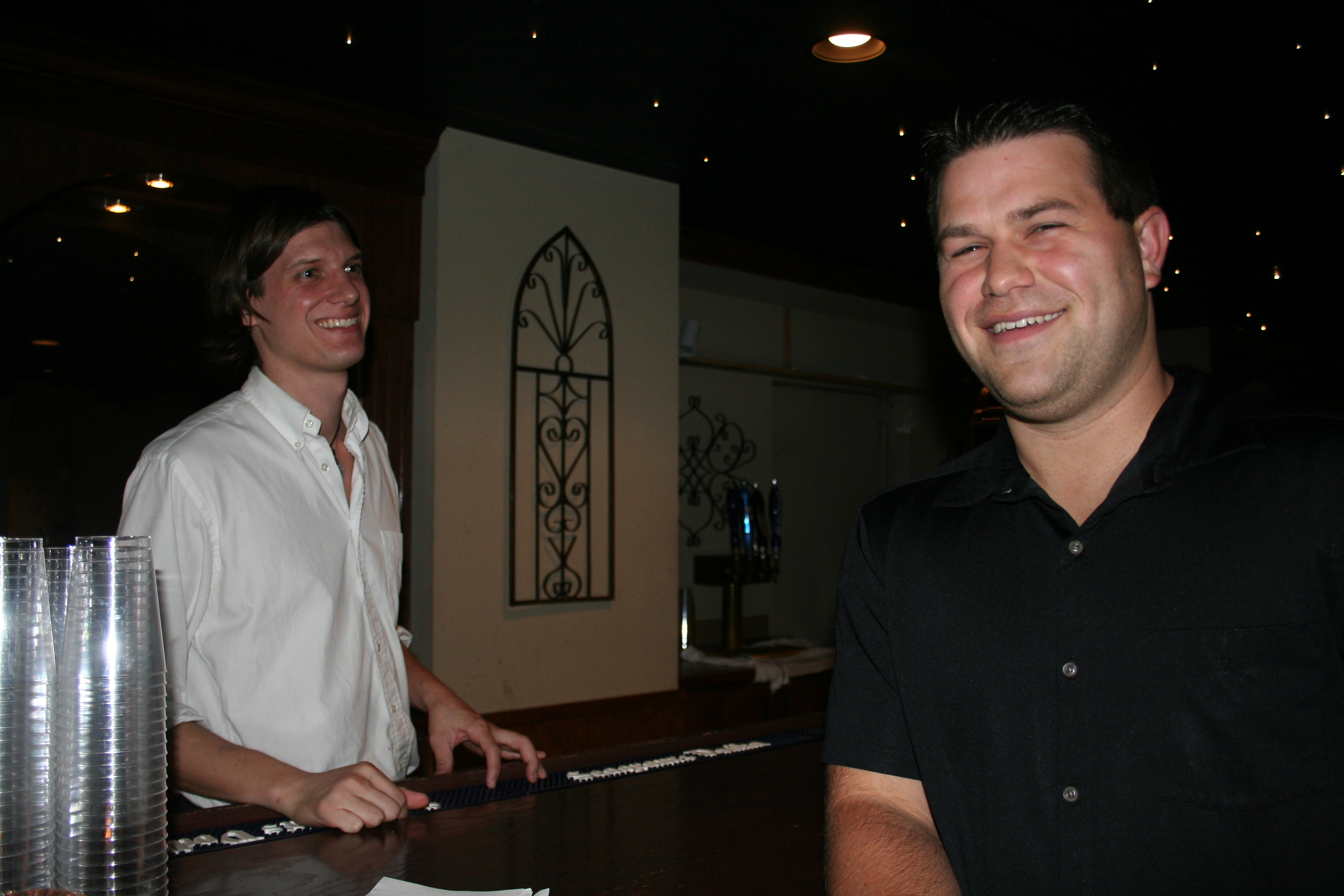 Matt Tate chats with bartender Jarrod Hale at the party.