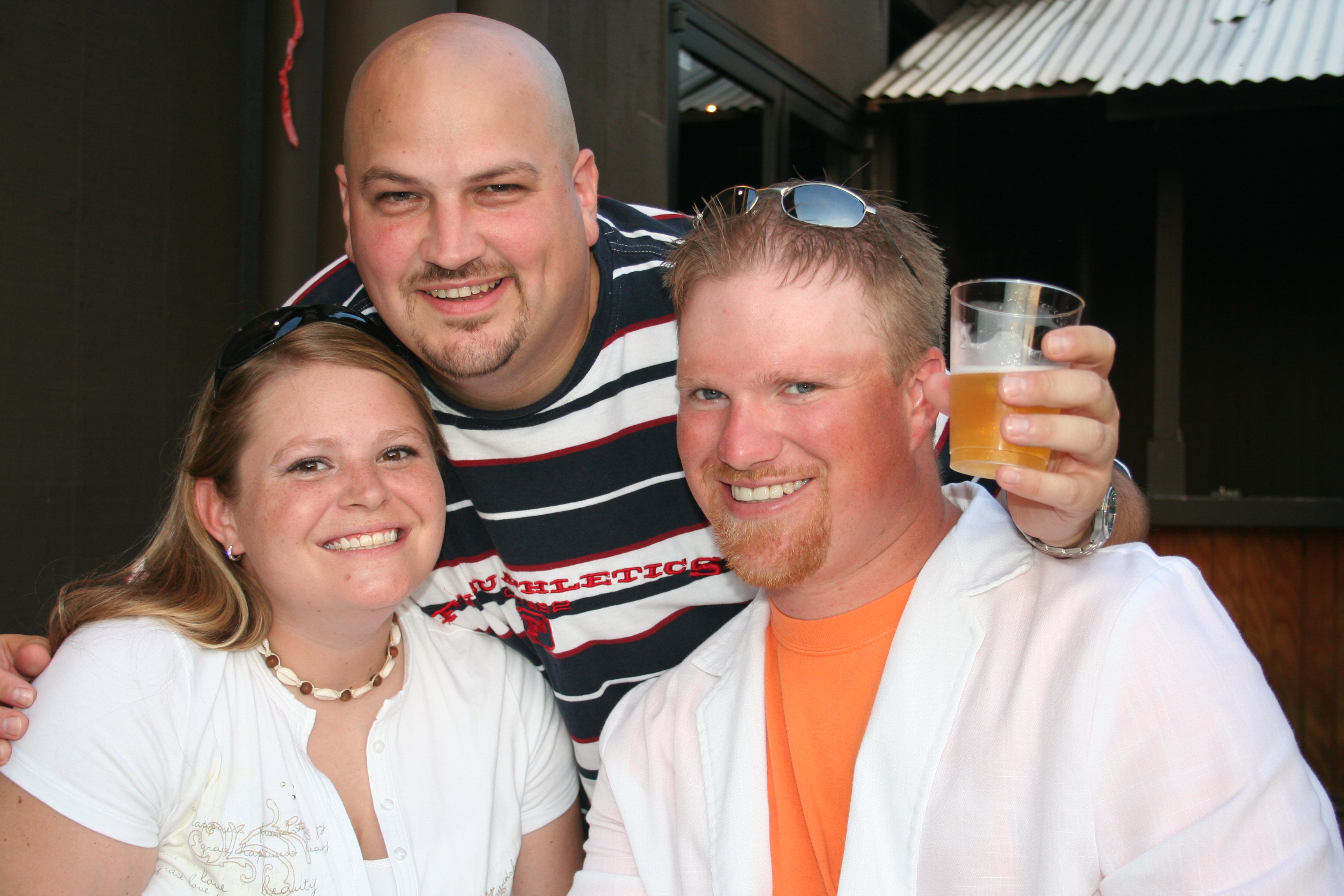 Courtney Lessenberry, Doug Miles and Mark Goedsch enjoy the patio at the party.