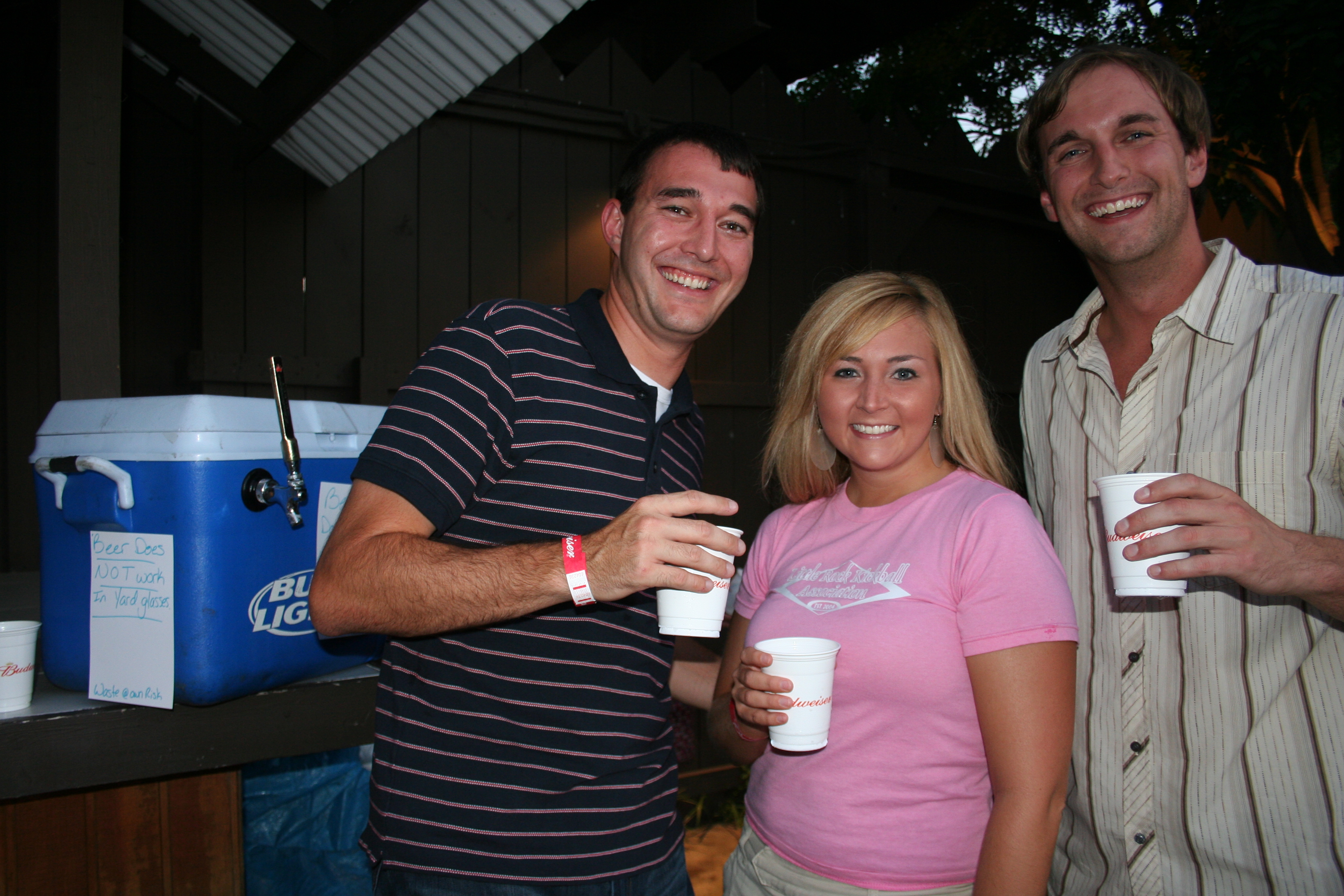 Shaun Harms, Hannah Ashen-Brenner and Chad Joslin make sure the keg works.