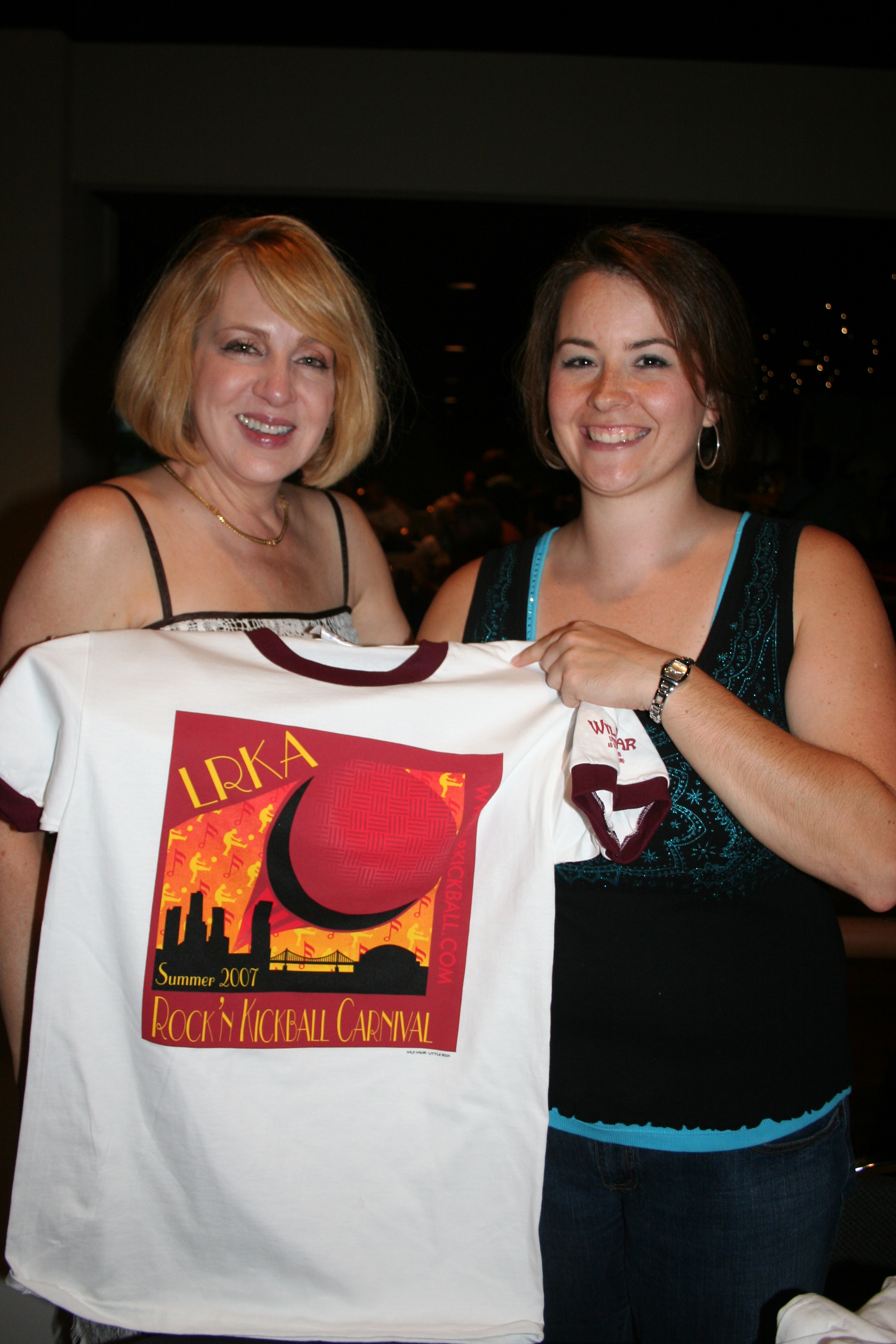 Cindy Steele and Adriane Stramel show off a t-shirt available to purchase.