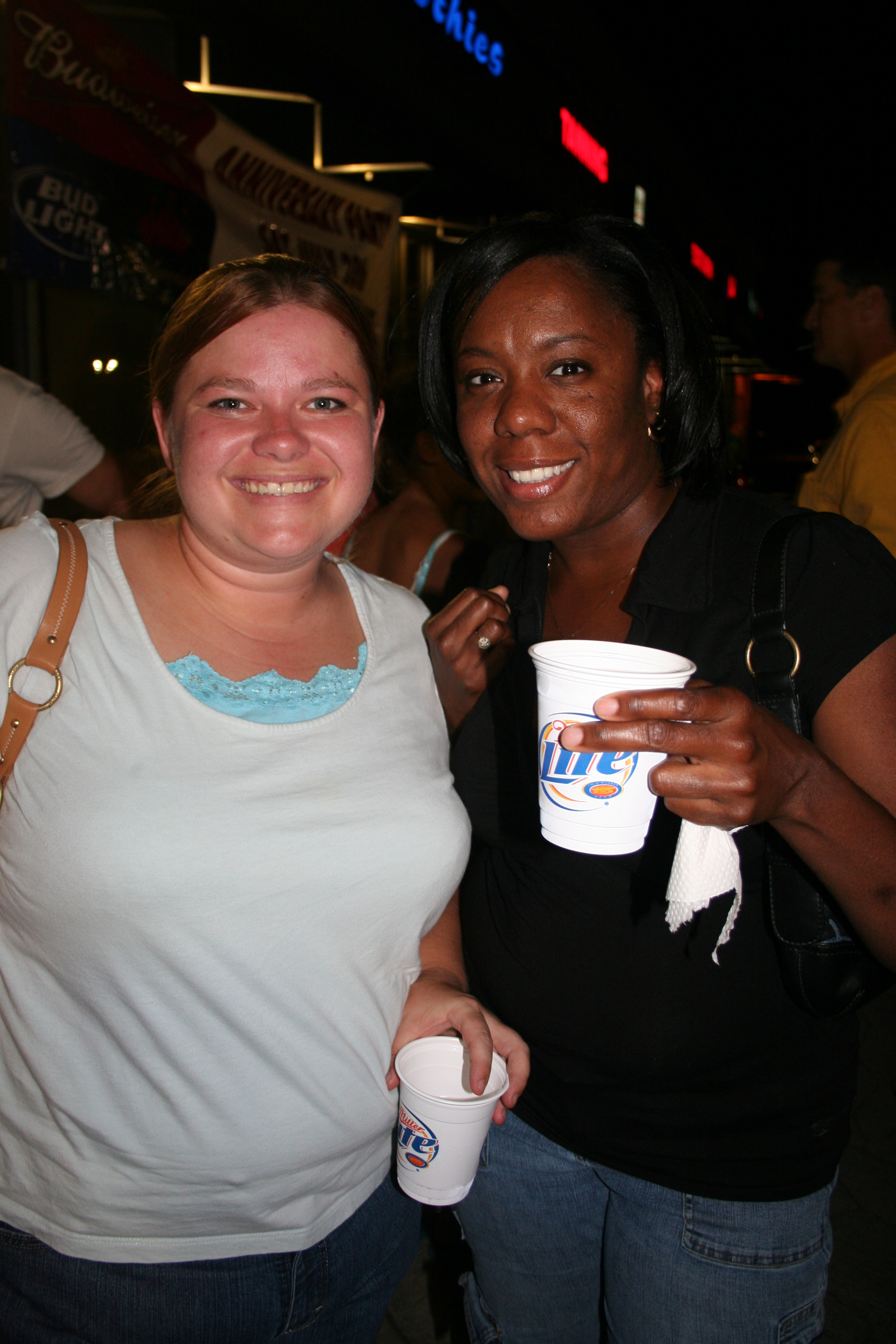 Sarah Schwankhaus and Monica Young enjoy a cool drink outside.