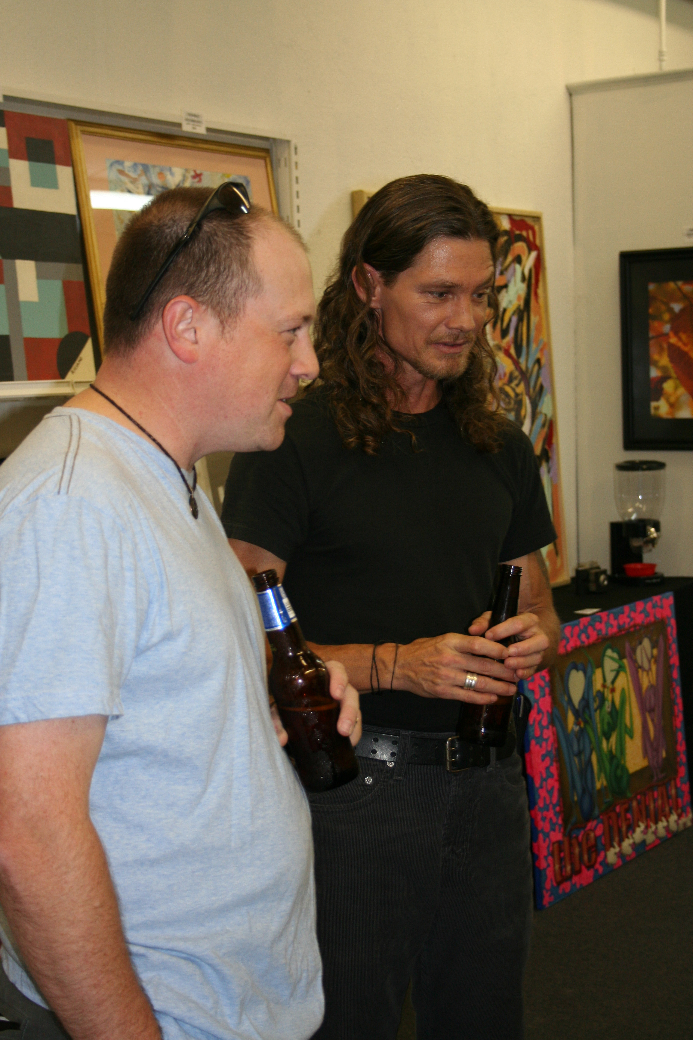 Thomas Pickle of North Little Rock chats with Riciano Art Gallery owner Terry Riciano during "Art After Hours" on Saturday.