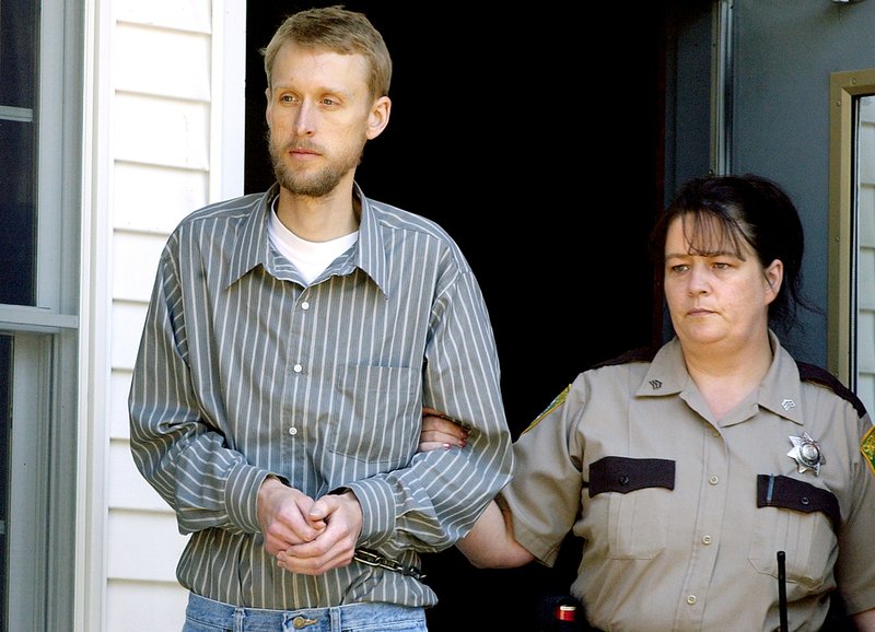 Christian Nielsen, left, is led out the back door of the Oxford County Superior Courthouse to a waiting police cruiser in Paris, Maine, on Thursday, Sept. 13, 2007. L