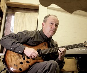 Guitar teacher Michael Carenbaur works with a student during a private lesson at the UALR Fine Arts Building. 