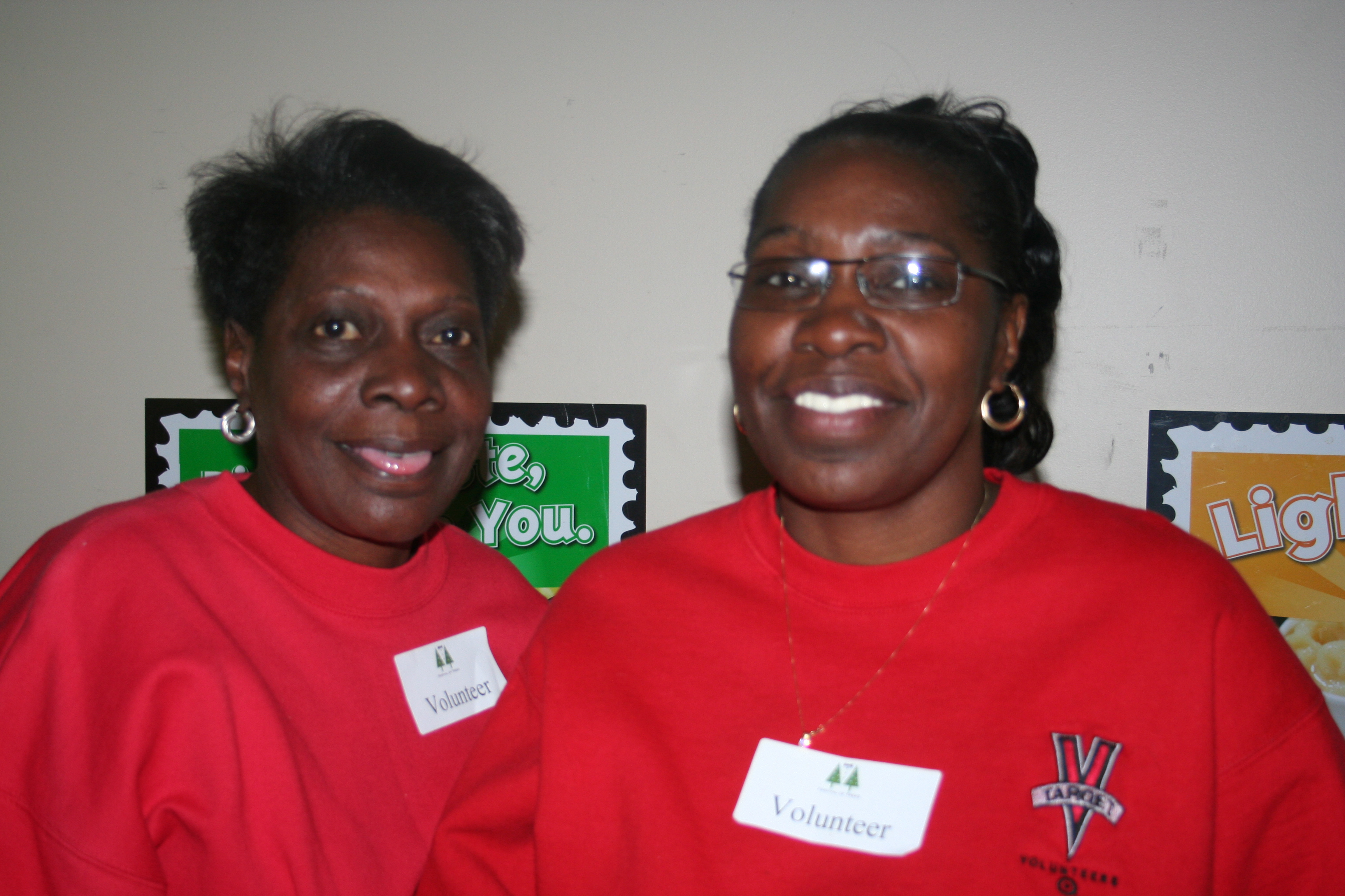 Pat Tolbert and Pauline Holloway serve food from Tropical Smoothie to the guests.