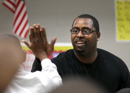 Jimmy Hinton gives a high-five to a fourth-grader at Washington Elementary School in Little Rock. 