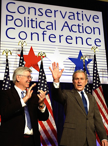 President Bush waves as David Keene of the American Conservative Union applauds at left, as he arrived to make remarks to the 35th Conservative Political Action Conference, Friday in Washington.
