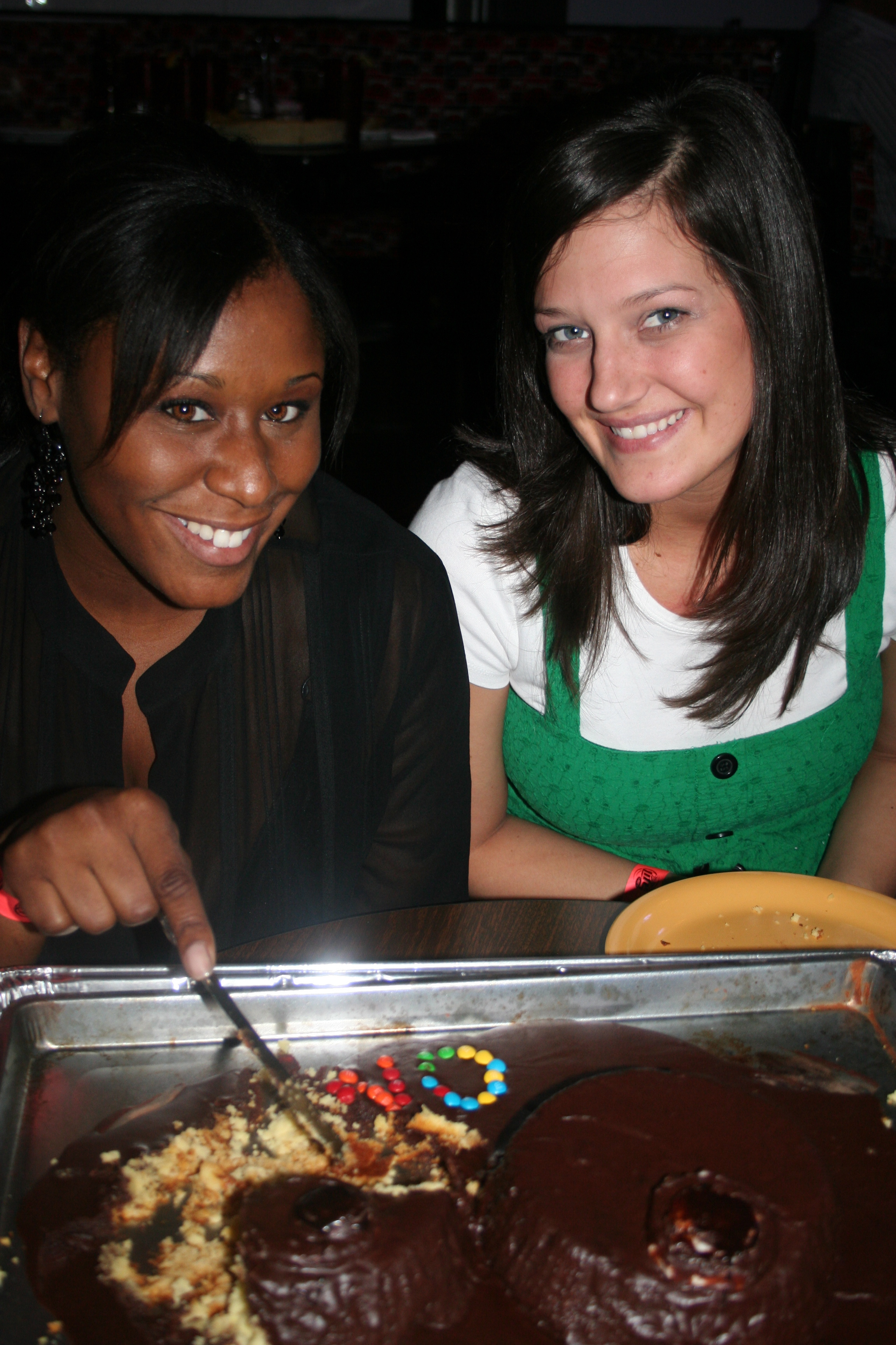 Adrienne Collins and Christy Pianalto enjoy cake for Adrienne's celebration.