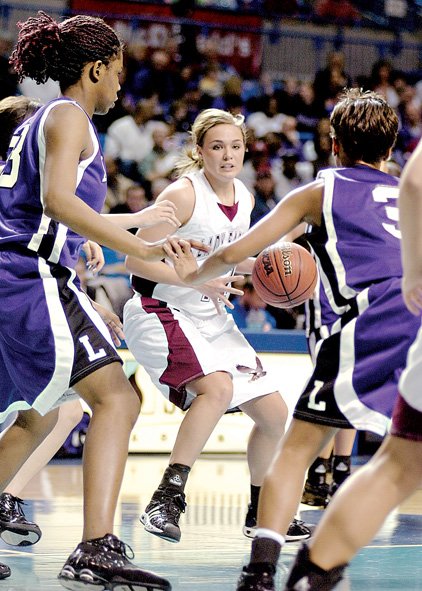 Huntsville's Jo Beth Williams tries to find a seam in the Lonoke defense in the Class 4A girls' championship game on Thursday at the Summit Arena in Hot Springs. Williams had 15 points in the Lady Eagles' victory, giving longtime Coach Charles Berry his second state title.