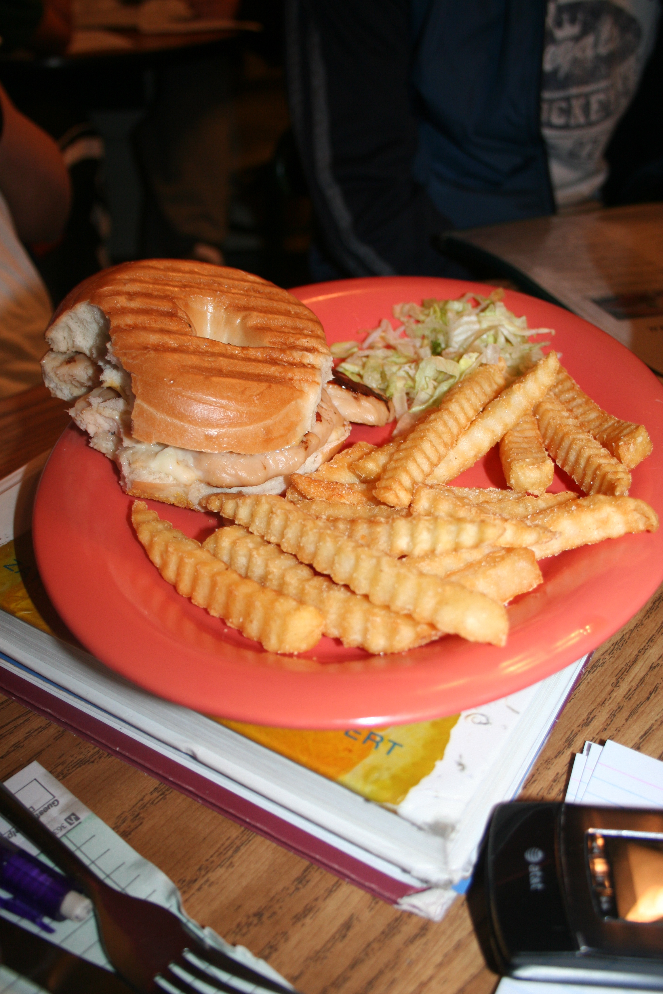 A grilled chicken sandwich for a snack while studying.