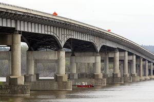 Searchers comb the Arkansas River under the Interstate 430 bridge for missing workers that fell into the river when the scaffold they were working on collapsed.