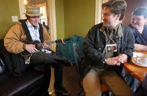 Jody Hughes plays ukulele for the benefit of cafe patrons at a mixer for Ozark Foothills FilmFest guests, including Sean Tracey and Sandy Qualls. Tracey (second from right) is a filmmaker from New Hampshire who traveled to Batesville to screen his documentary The Jesus Guy