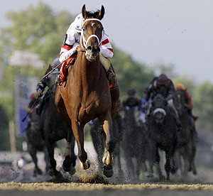 Big Brown ridden by Kent Desormeaux crosses the finish line to win the 133rd Preakness horse race at Pimlico Race Course on Saturday in Baltimore.