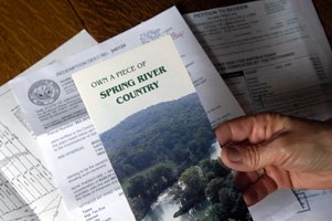 The brochure in Colleen Crowley's hand touts "Own a piece of Spring River Country."
