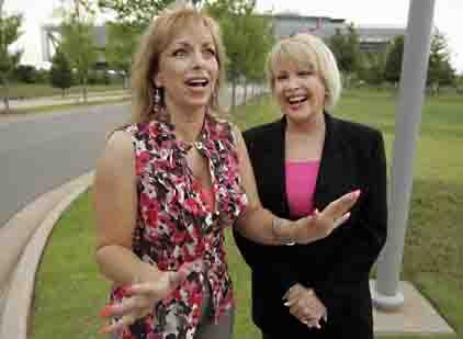Gennifer Flowers, right, laughs as she and Paula Jones are interviewed in front of the Clinton Presidential Library in Little Rock, Monday.