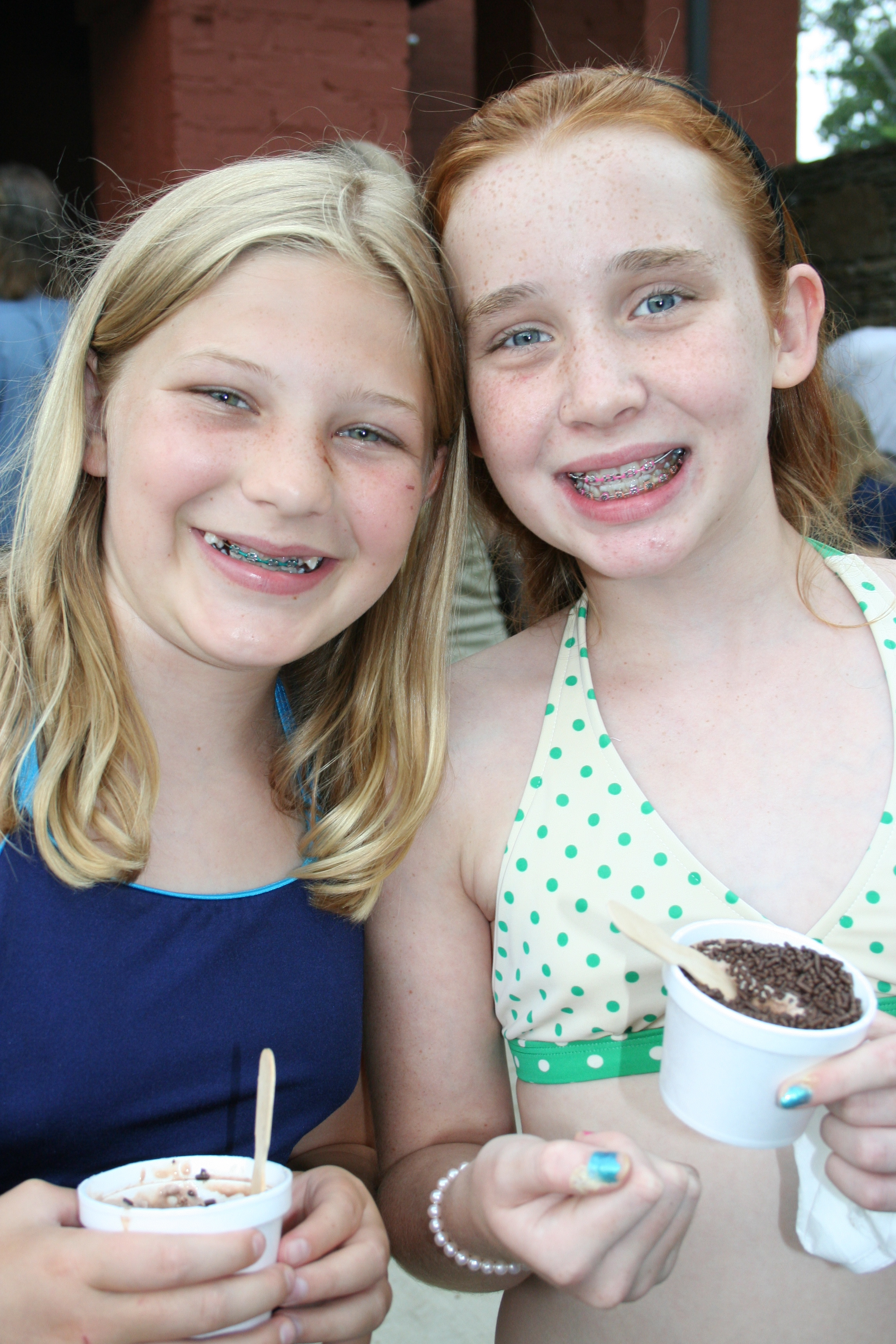 Rachel Reif and Rachel Lorsbach enjoy their ice cream in their swimsuits.