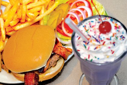 A purple vanilla shake complements the BBQ Bacon Cheddar Burger at The Purple Cow.
