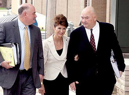 Cynthia and Tom Coughlin (right) leave the Benton County Courthouse with attorney Tim Brooks on Thursday.