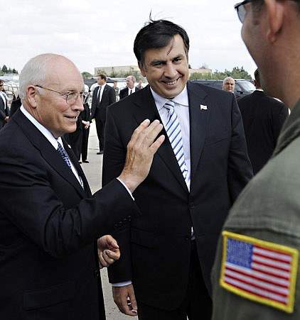 Georgian President Mikhail Saakashvili, center, and U.S. Vice President Dick Cheney, left, speak to a U.S. air force personnel member as they inspect humanitarian aid at an airport in Tbilisi, Georgia Thursday.