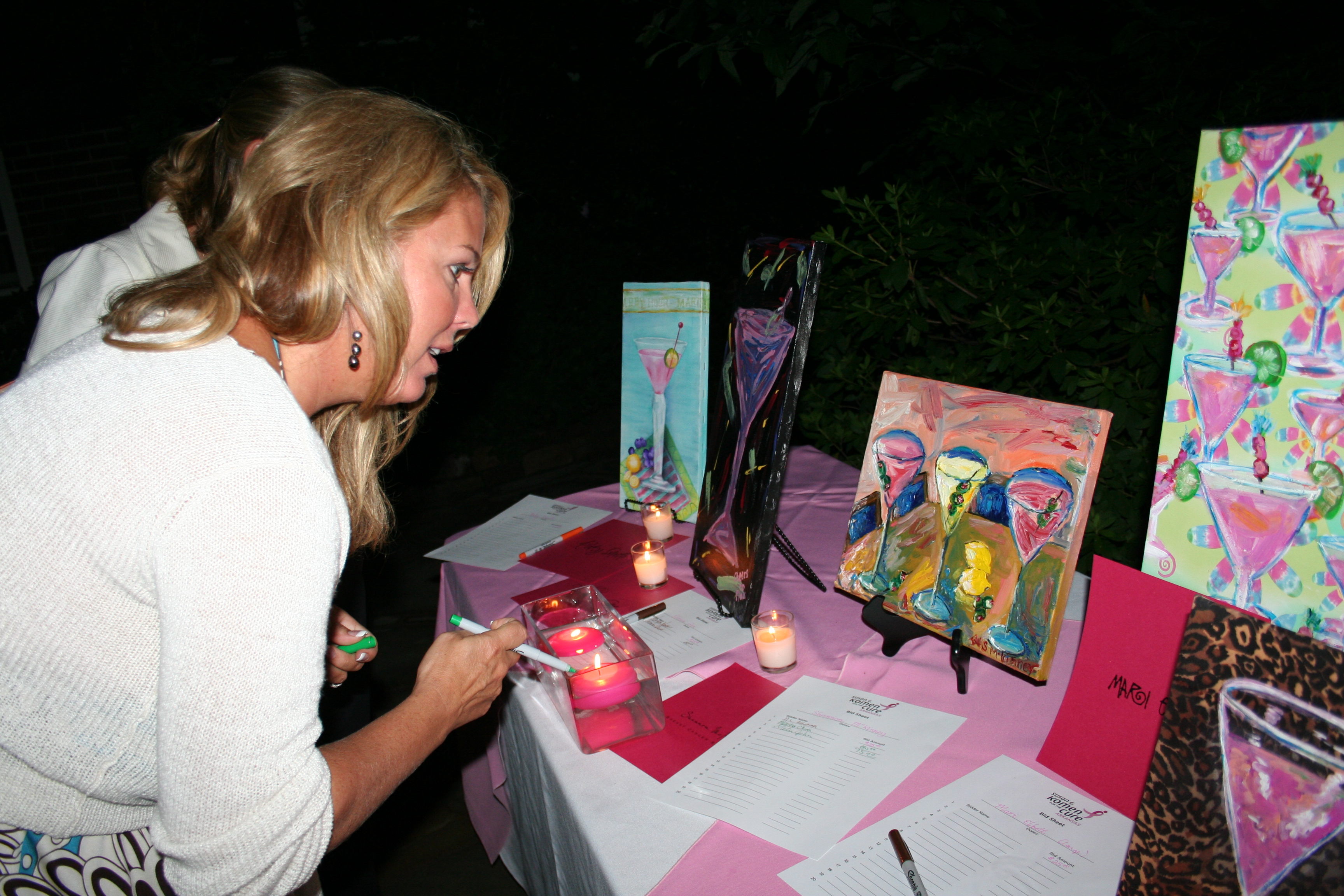 44. A party guest checks out the silent auction items.