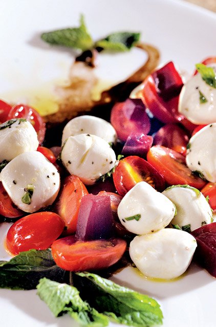 Caprese at Amalfi's involves marinated grape tomatoes, cherry-size buffalo
mozzarella and fresh basil over a balsamic vinaigrette.