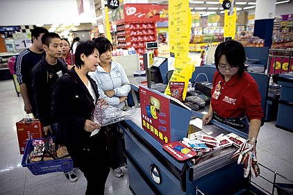 Customers wait to check out at a Wal-Mart Stores Inc. outlet in Beijing in this October 2008 file photo. The retailer says China is a key market for Wal-Mart.