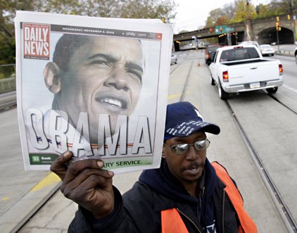 Jeff Thomas sells newspapers with a photo of President-elect Barack Obama on the front, in Philadelphia, Wednesday.