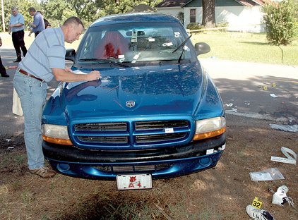 In this Arkansas State Police crime scene photo released Thursday, police gather evidence from Timothy Dale Johnson's Dodge pickup after he was fatally shot by state troopers and a Little Rock police officer in Grant County after a 34-mile chase from Little Rock on Aug. 13.