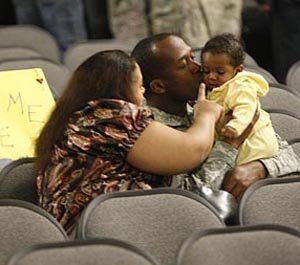 Sgt. Jermell Heath (middle) of Houston spends time with his wife Joeanna and 6-month-old daughter Jenesis on Wednesday night during a welcome home ceremony at Camp Shelby, Miss. Heath was returning home from a deployment to Irag with A Troop 151 Cavalry Regiment.