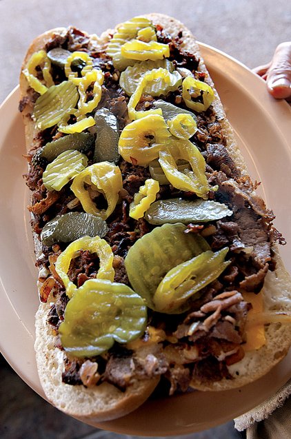 Famous Philadelphia Cheese Steak topped with pickles that might put off purists at Philam Gourmet on South University Avenue in Little Rock.