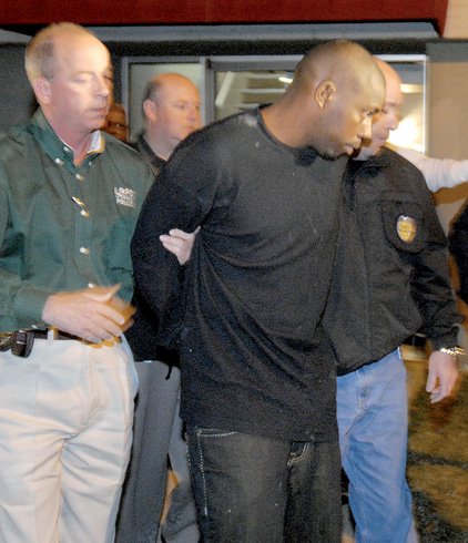 Little Rock police detective Stewart Sullivan (left) leads Curtis Lavelle Vance to a patrol car in this Nov. 2007 file photo.