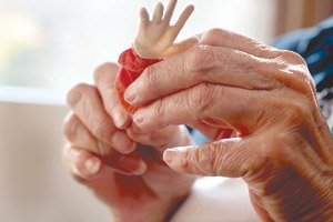 DeRue Johnson fashions a fabric doll's hand. Sewing is a family tradition, she says.