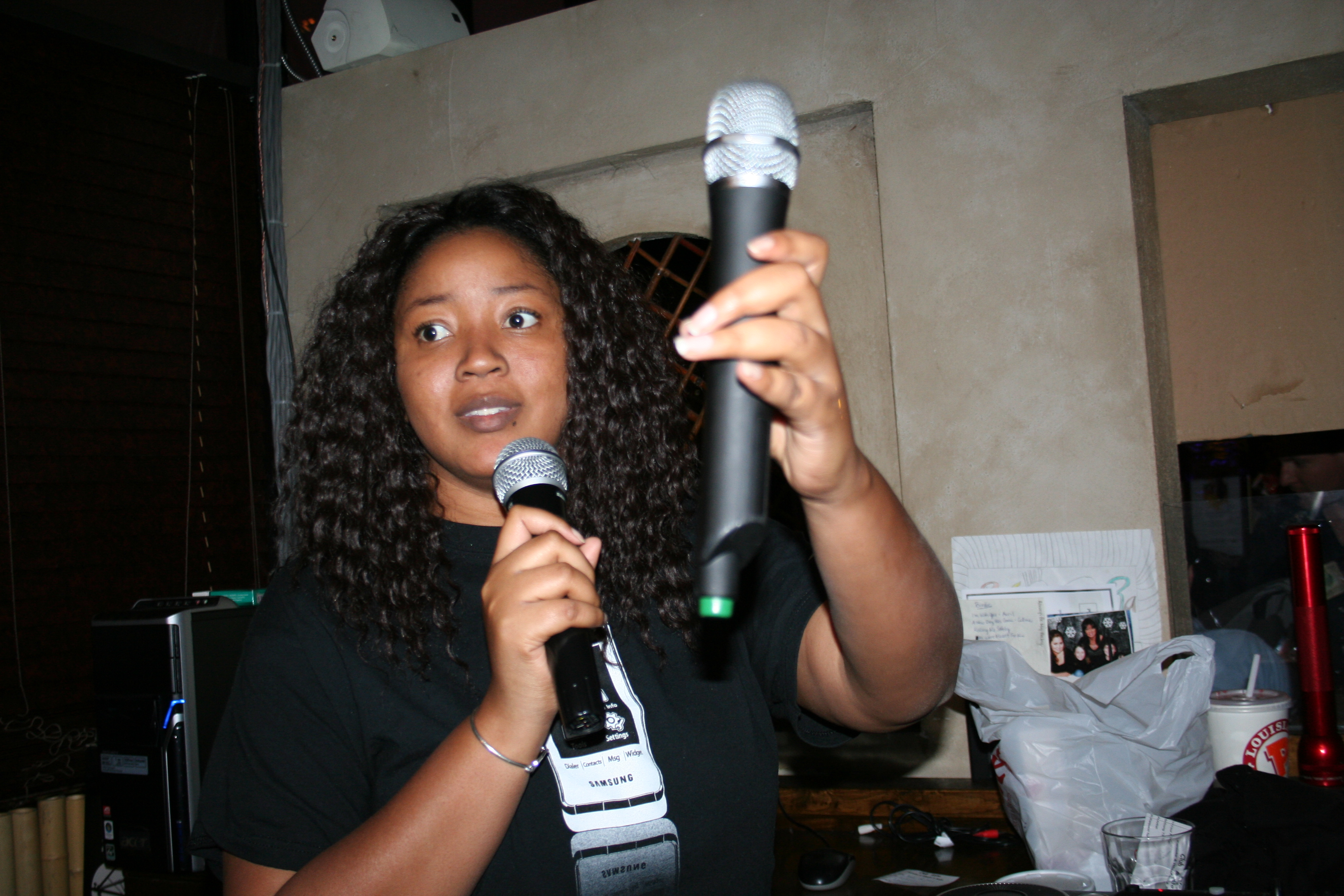 Keisha Parshaw passes the mic to get the karaoke started.