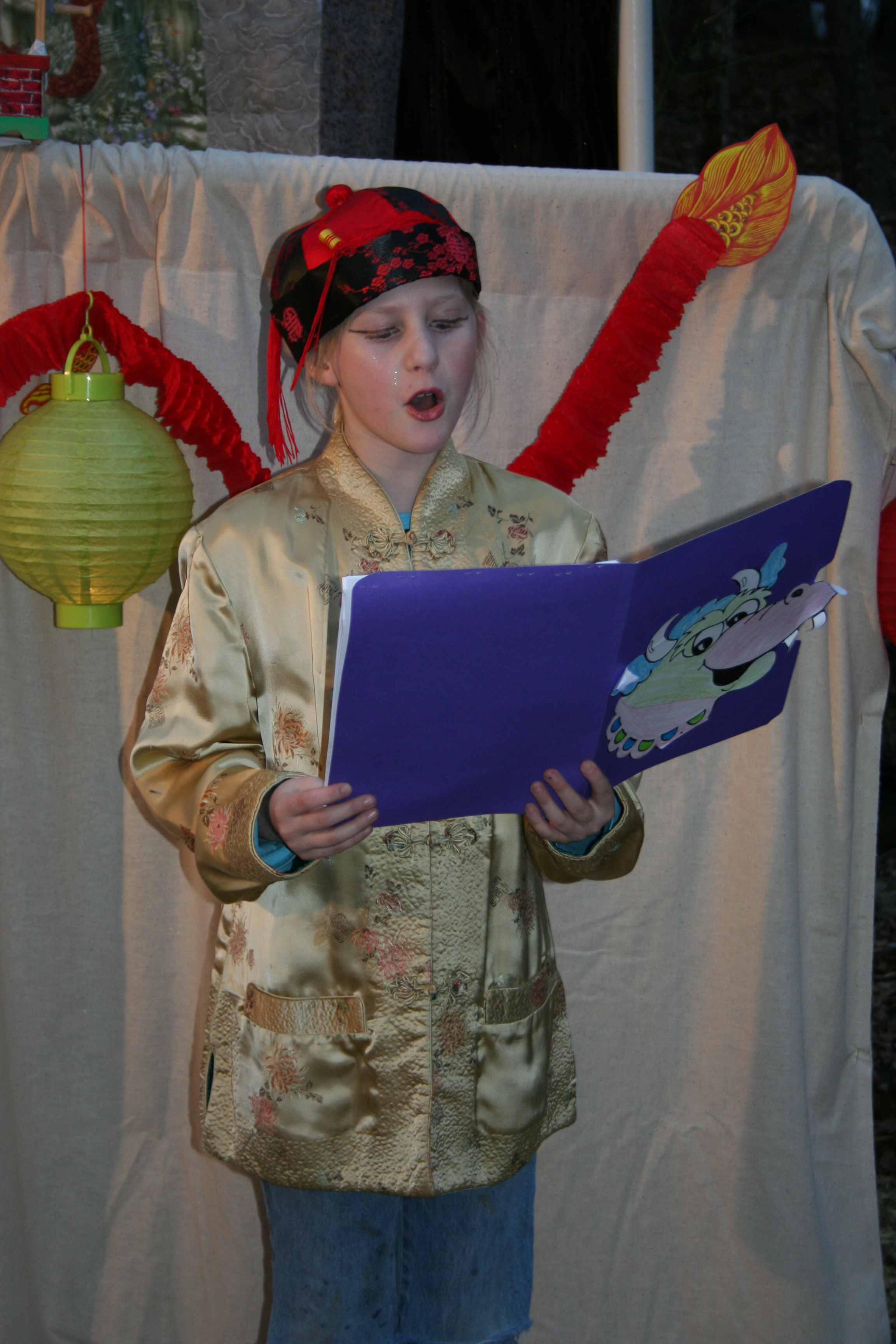 A youngsters reads in a cultural skit.