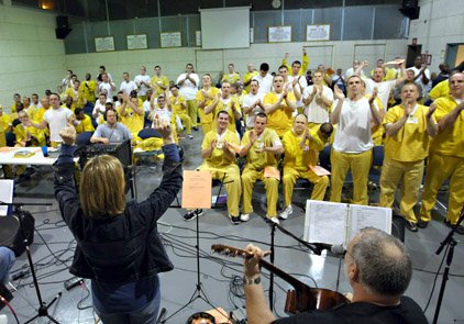 Inmates at the Central Arkansas Community Corrections Center in Little Rock applaud members of the prison band after a song. Many of the inmates will often sway and clap along to the group's rock music. 