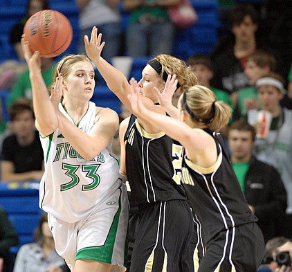 Valley Springs' Arielle Saunders (33) tries to pass the ball against triple coverage from Charleston during the Arkansas 3A State Championship Thursday at the Summit Arena in Hot Springs.